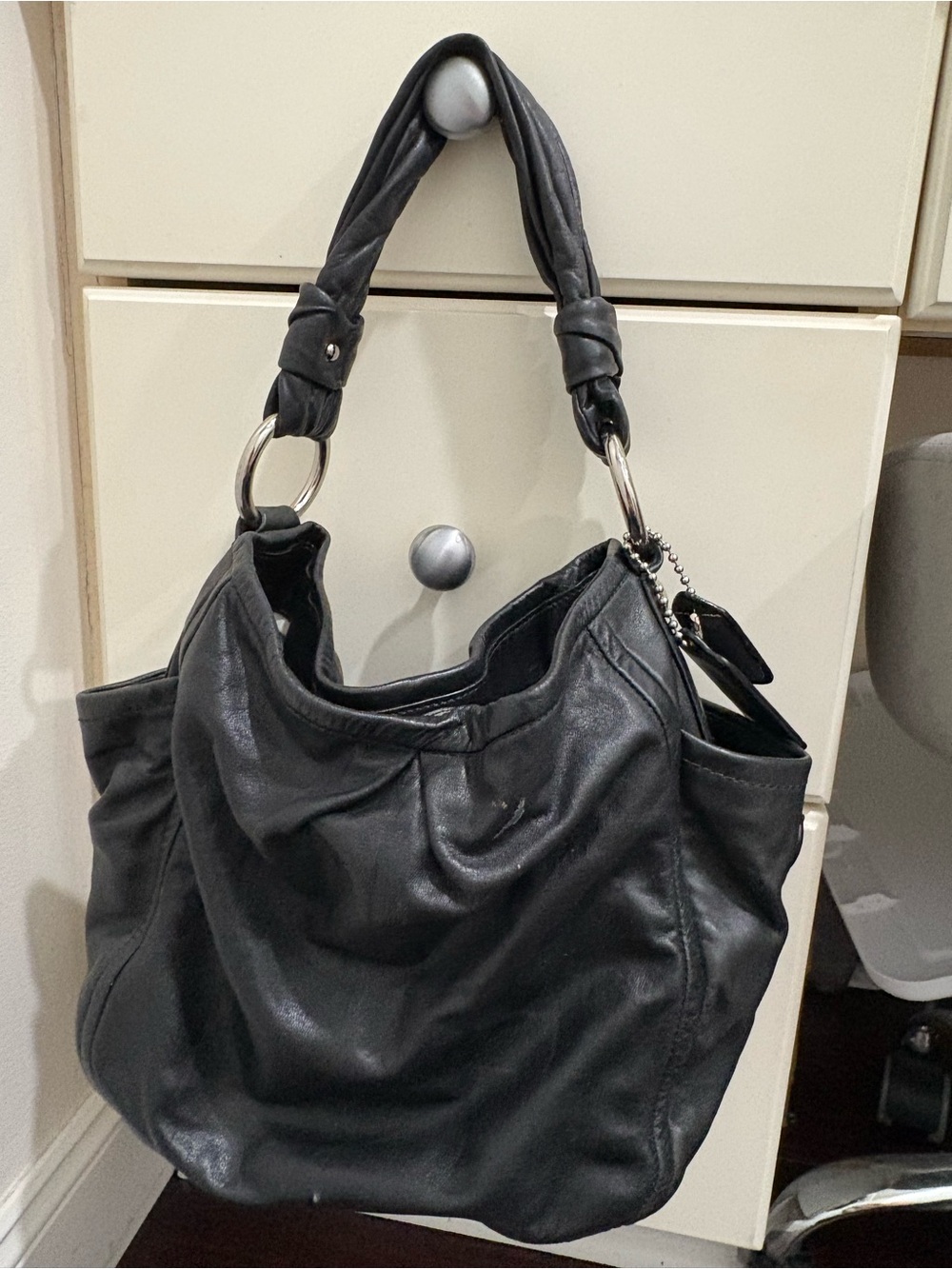 Sleek Black Leather Shoulder Bag with Silver Ring Accents